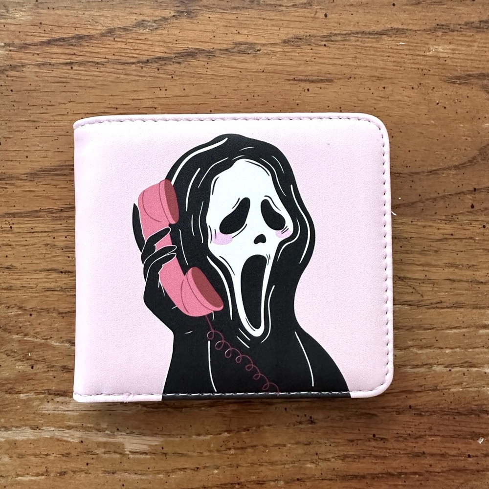Brand new never used Ghost Face Pink wallet. Photos show size.